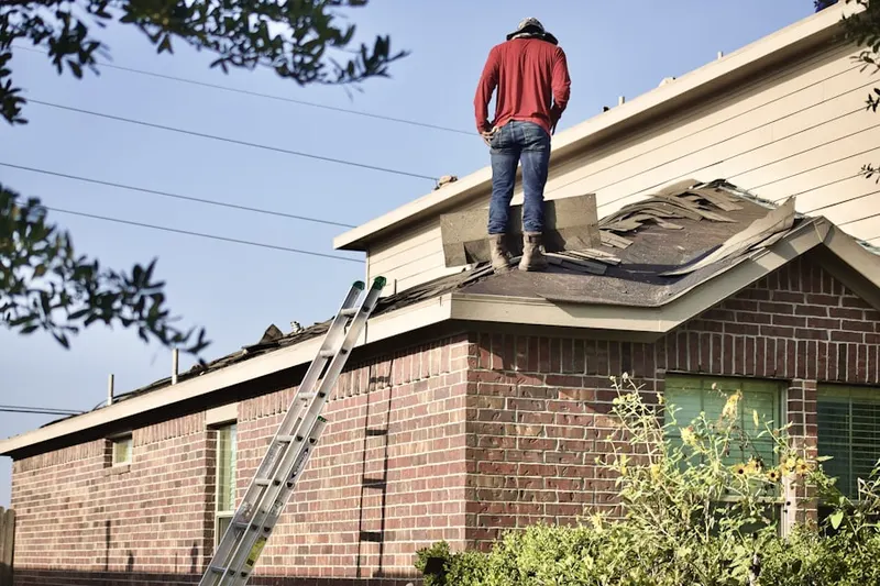 Professional roofer working on a residential roof in Buffalo